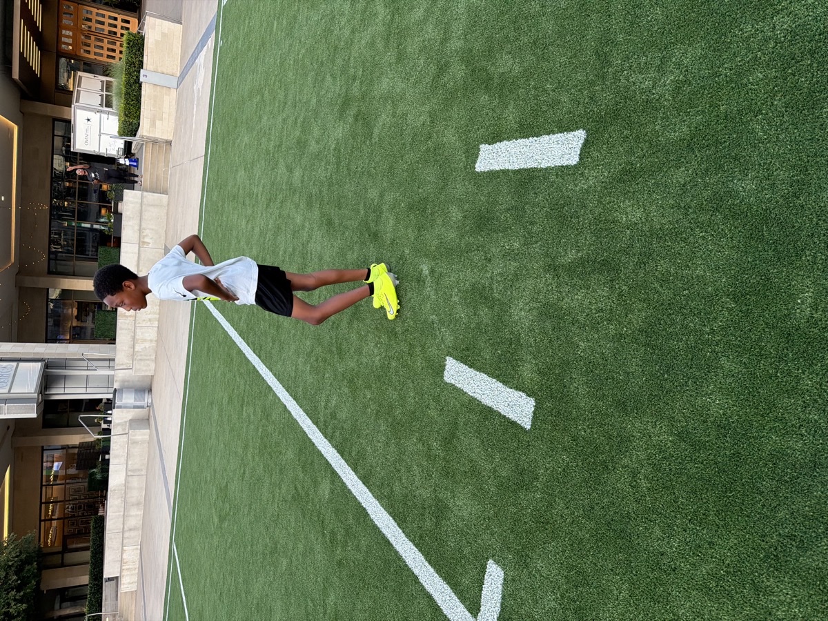 Frisco Elite player stretching on the turf — 2026 season